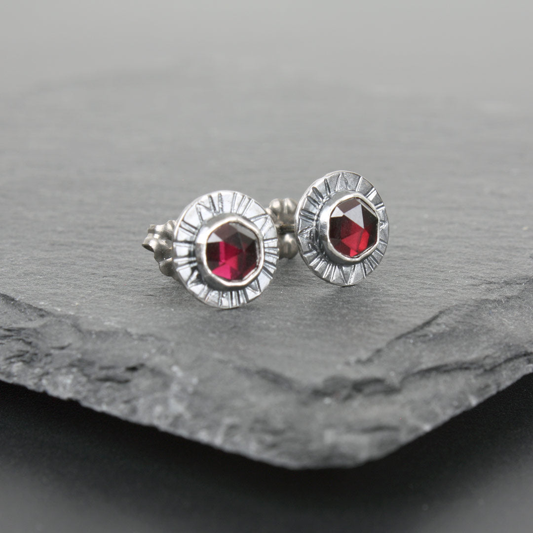 Sterling silver earrings with faceted rose-cut garnets.