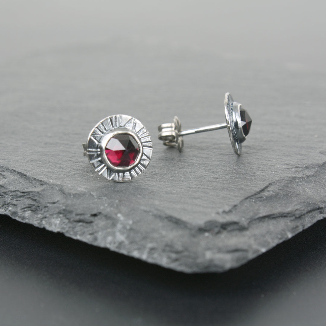Sterling silver earrings with faceted rose-cut garnets.
