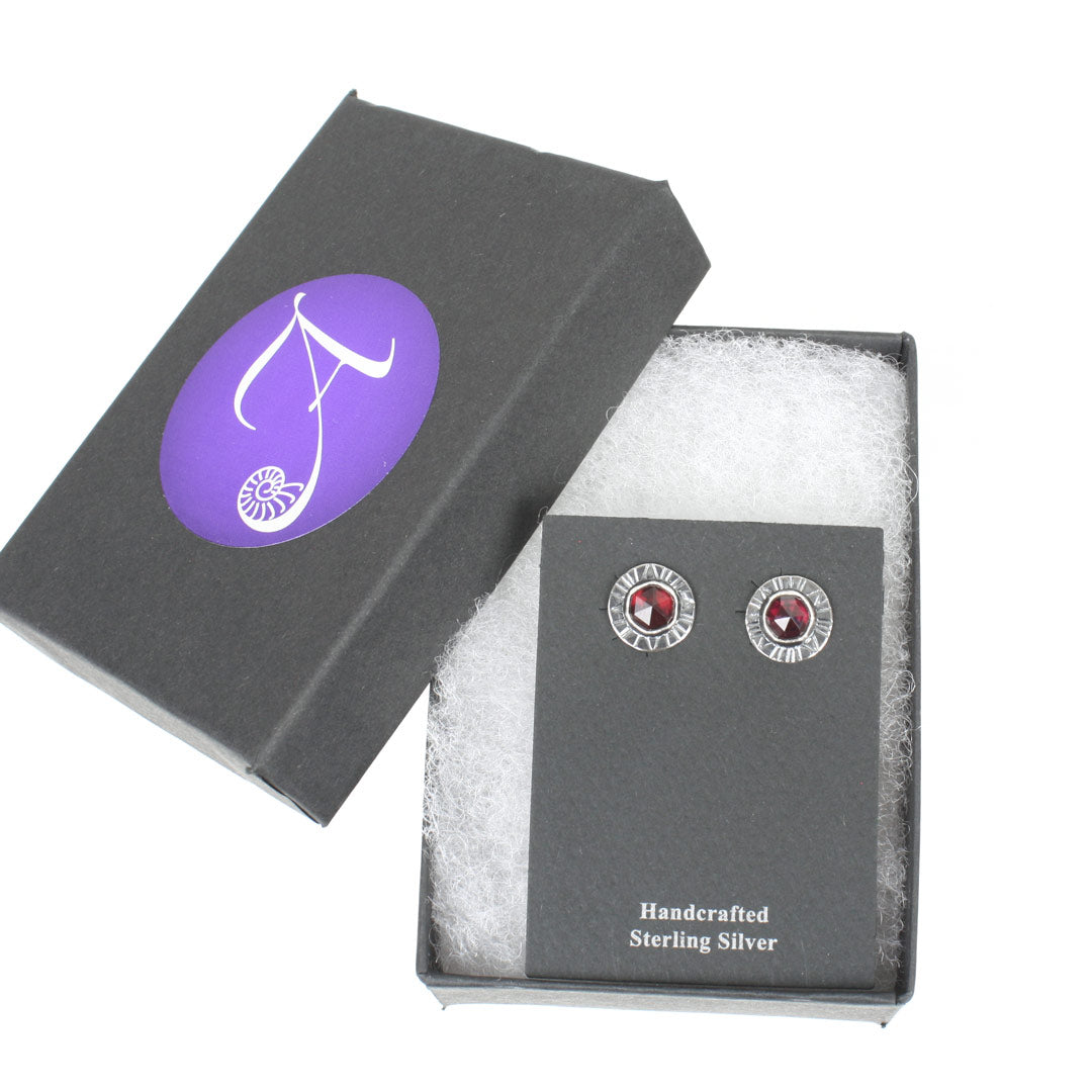 Sterling silver earrings with faceted rose-cut garnets, displayed in a black gift box with the Arcana Metalwork logo.