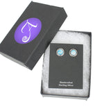 Sterling silver earrings with sky blue larimar. Shown in a black gift box with the Arcana Metalwork logo.